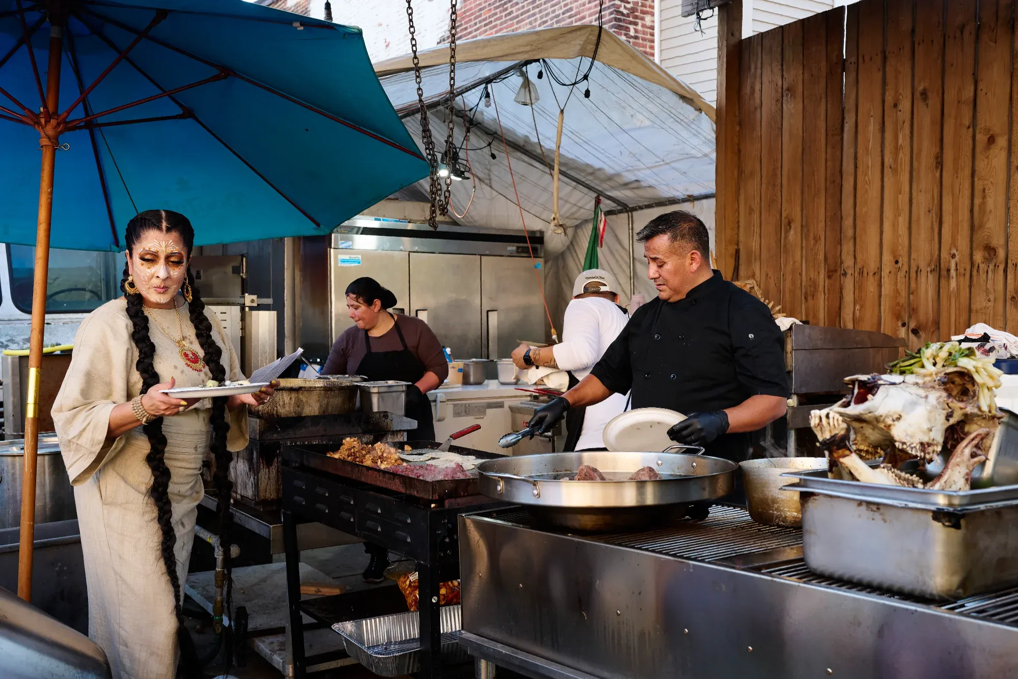 Mariangeli Alicea Saez relays orders while Chef Dionicio Jiménez works the grill at Cantina La Martina