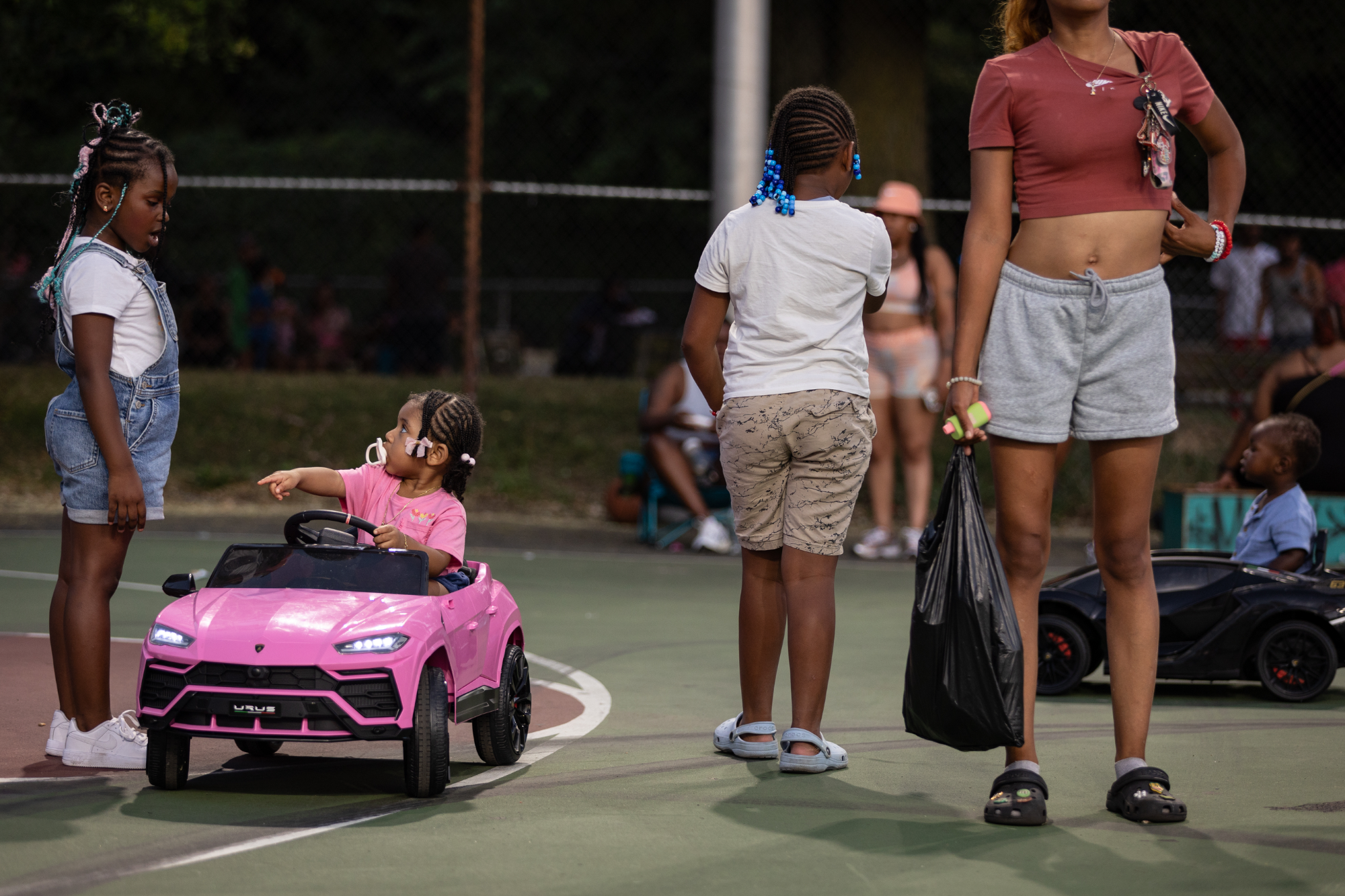 Royal rides a toy car across the court after the game