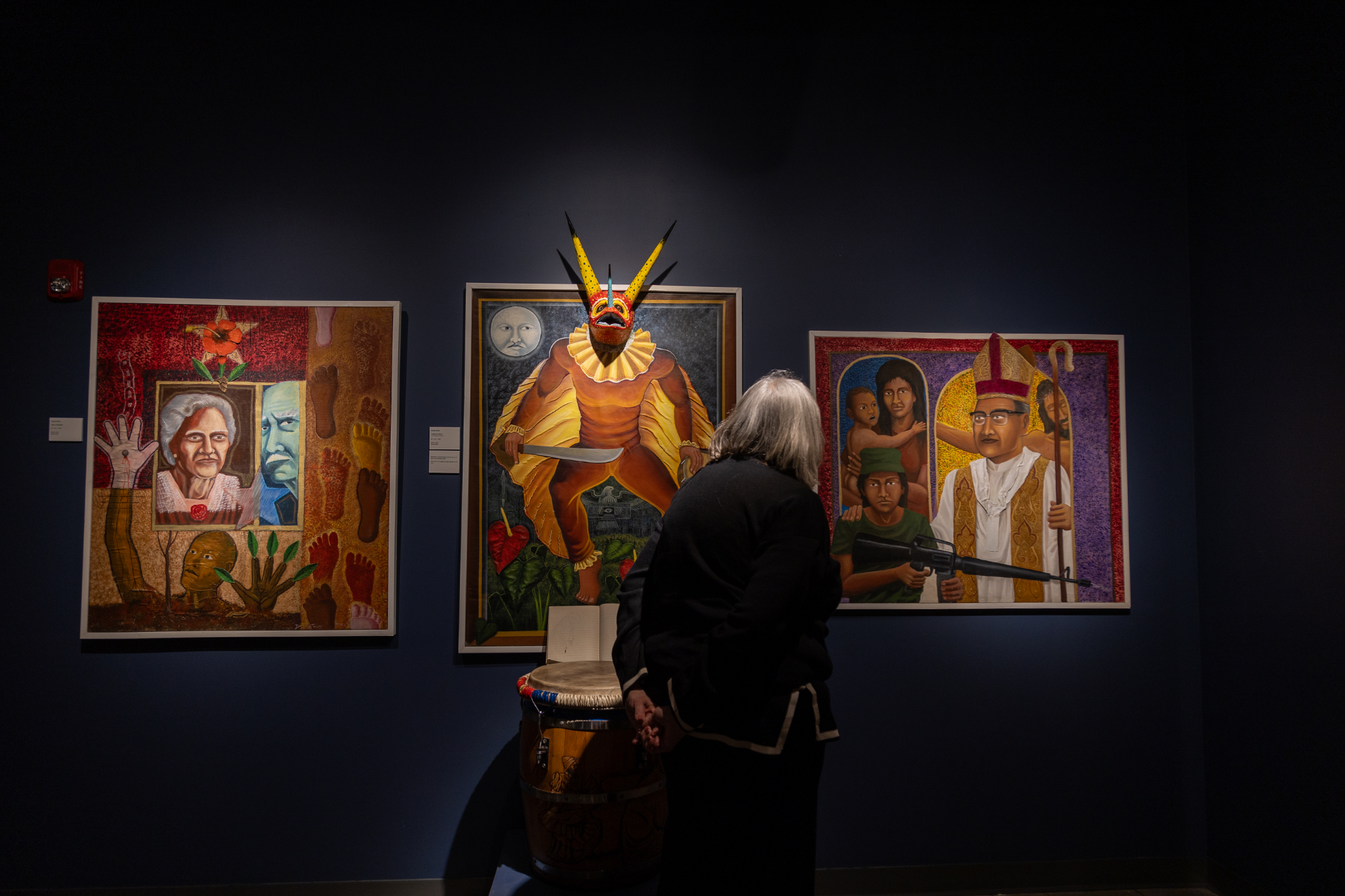 Guest views artwork at Danny Torres exhibition at Esperanza Arts Center