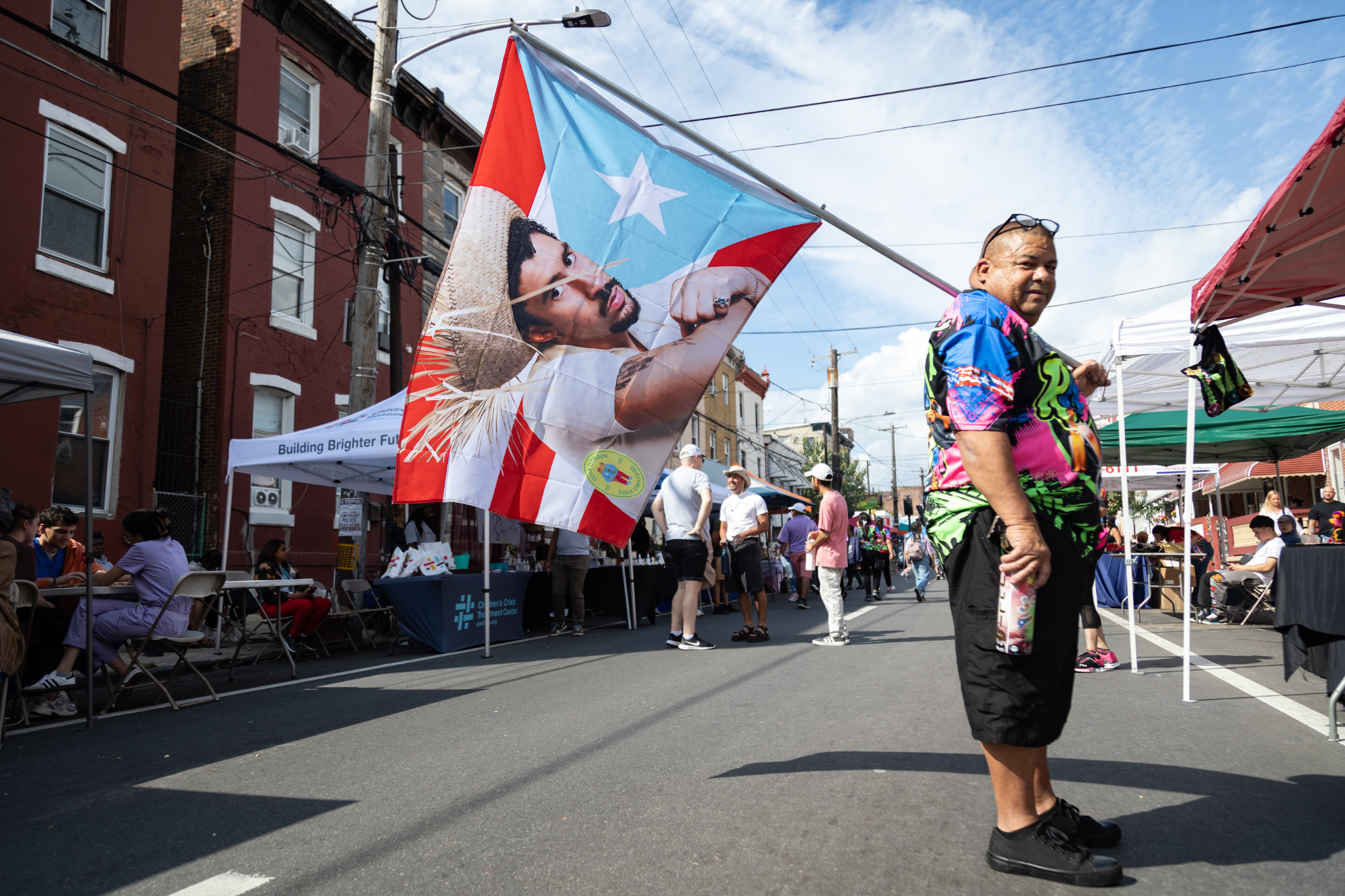 Julio Gonzales holds Puerto Rican flag featuring Bad Bunny