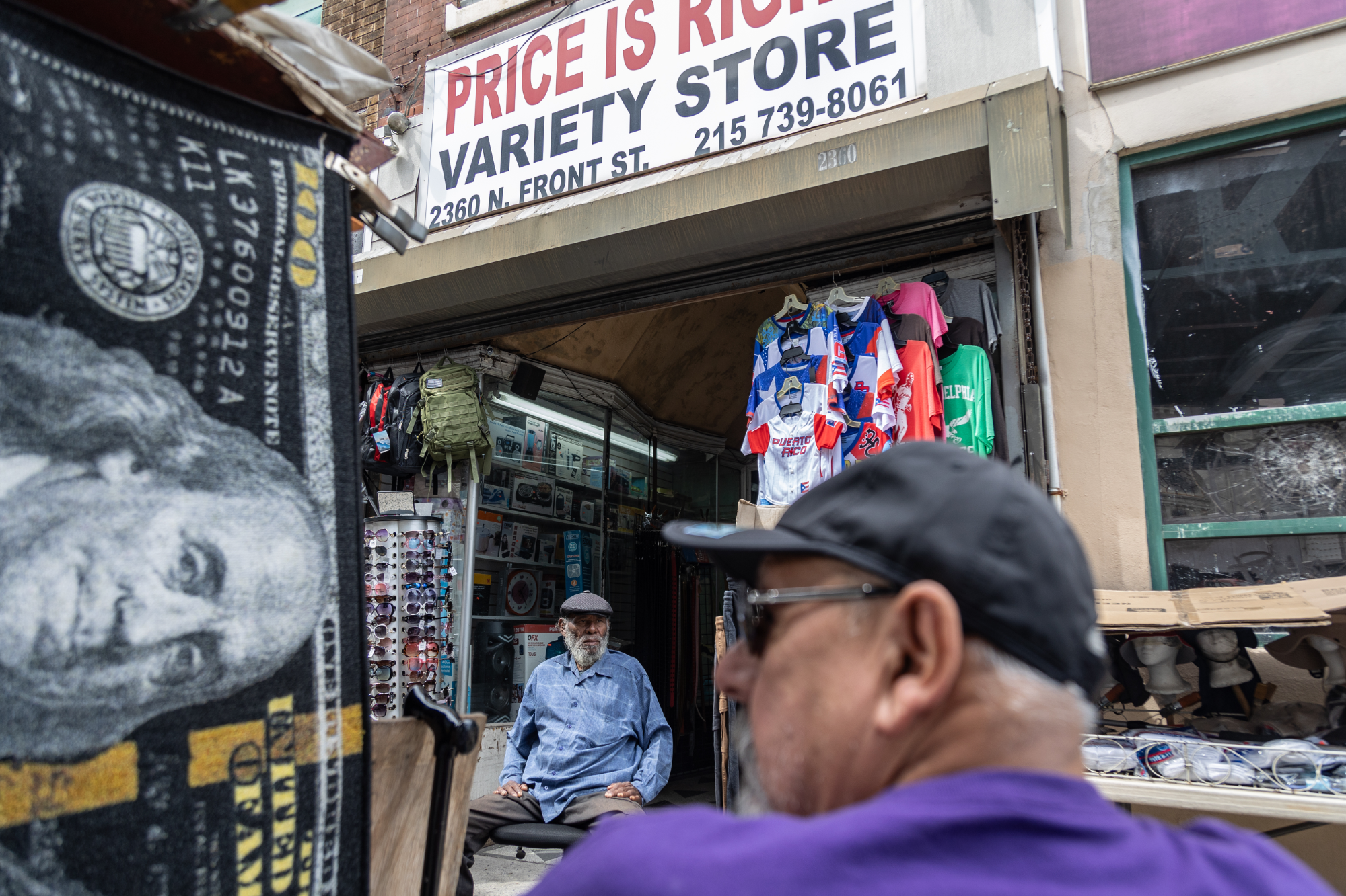 Victor Montañez sits outside Price Is Right Variety Store on North Front Street