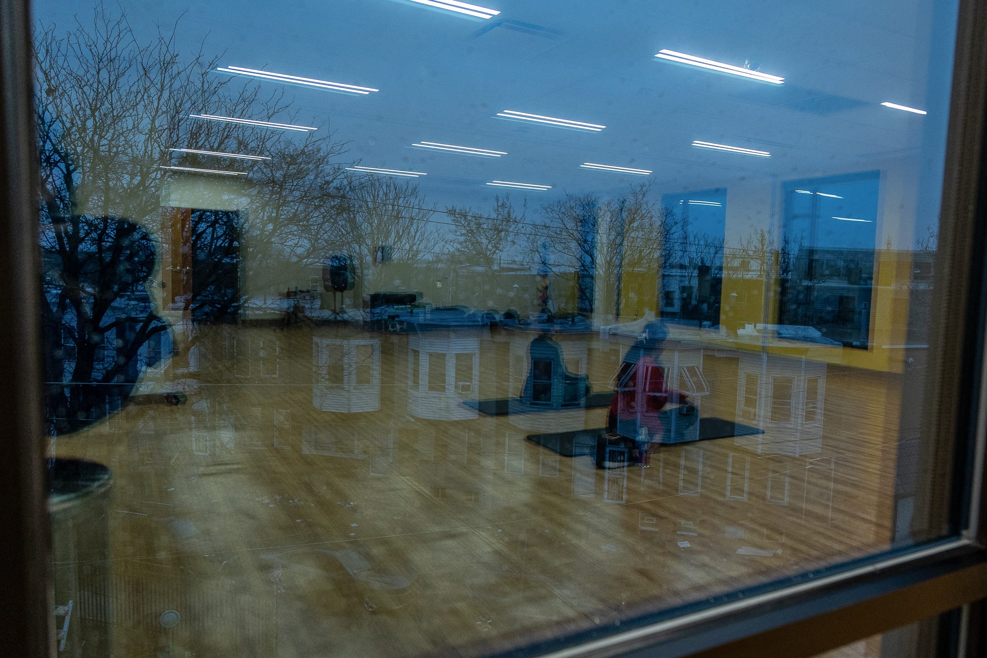Yoga class reflected in window at CORE Esperanza Health Center