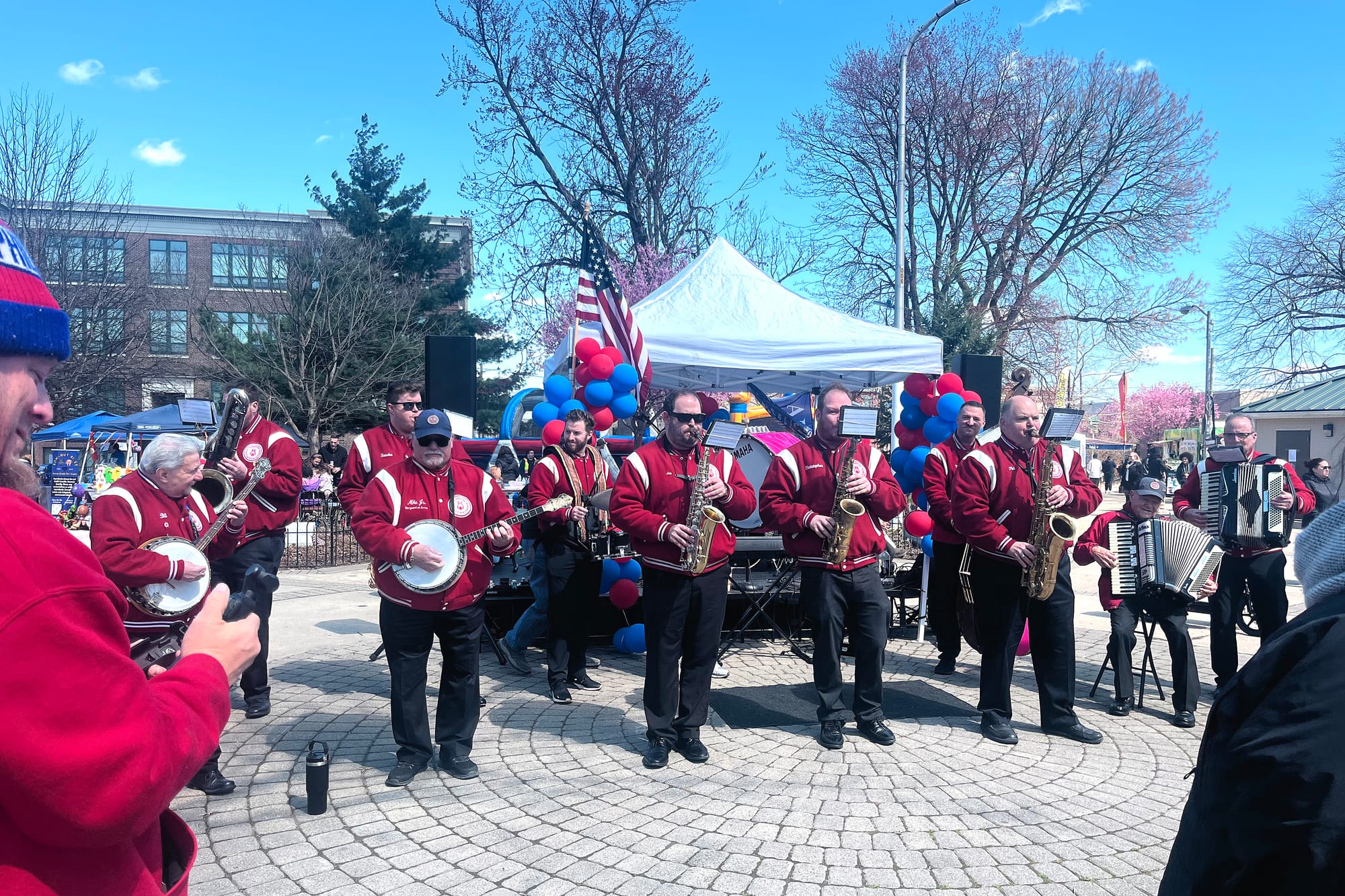 Members of the Polish American String Band perform in matching red jackets at the Port Richmond 179th Anniversary Festival at Campbell Square Park in Philadelphia.