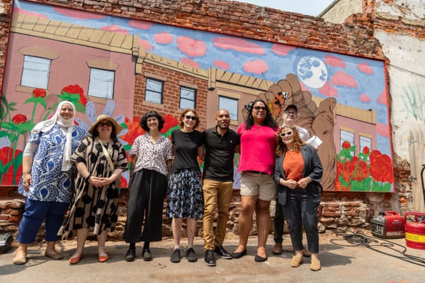 Local artist creates new mural at the Love Lot: “Reciprosity is a mutual exchange”