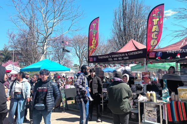 Attendees browse food vendors, including a taco stand, at the Port Richmond 179th Anniversary Festival at Campbell Square Park in Philadelphia.