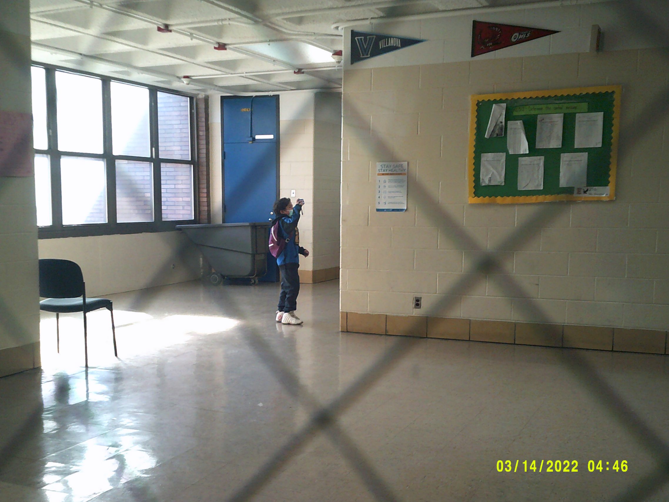 Elkin student Joel takes a photo of a friend at school for his Photovoice project.